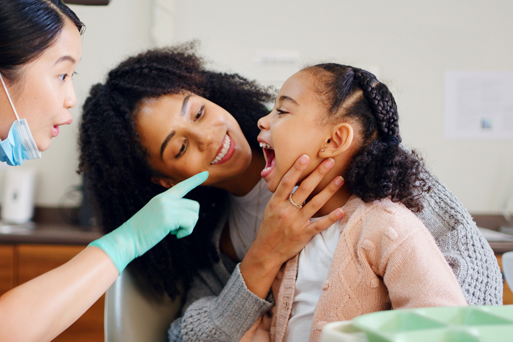 young patient and mother talking to orthodontist