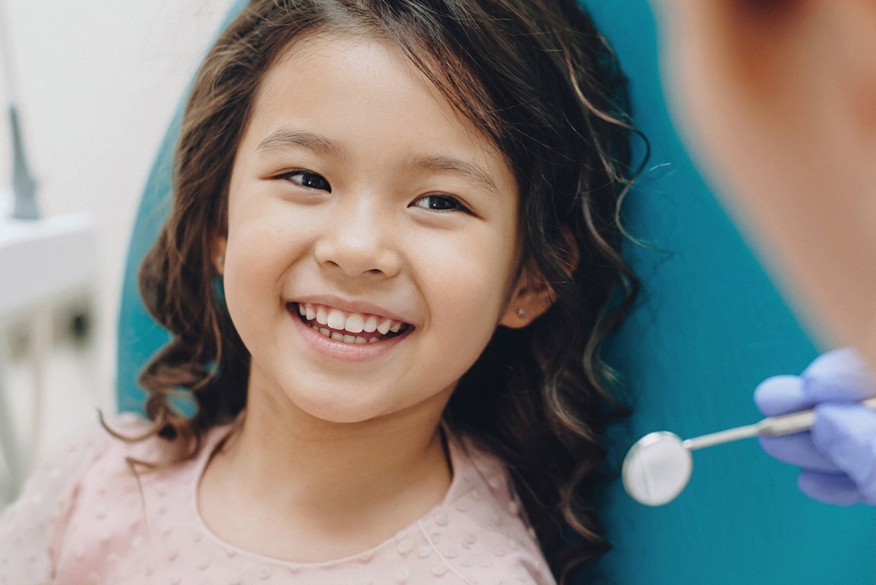young girl smiling in dental chair