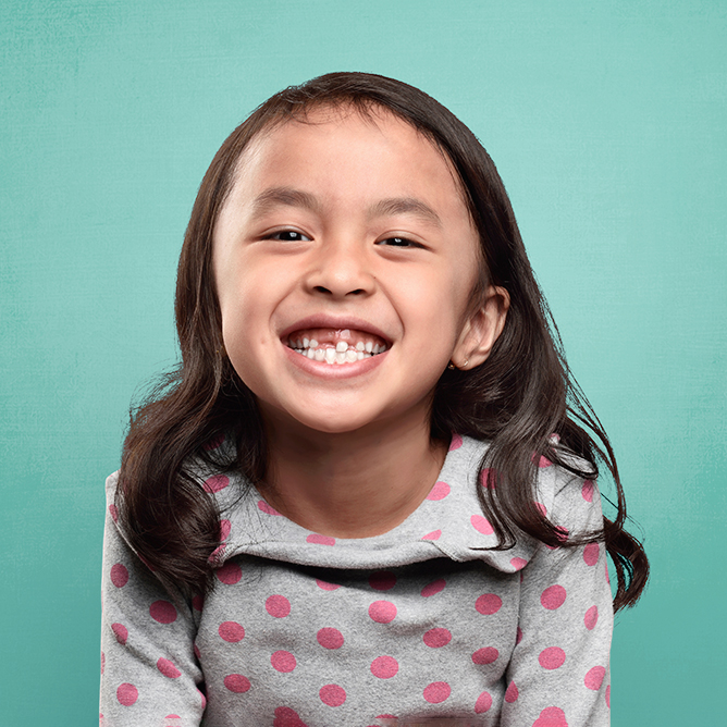 young girl with missing front tooth