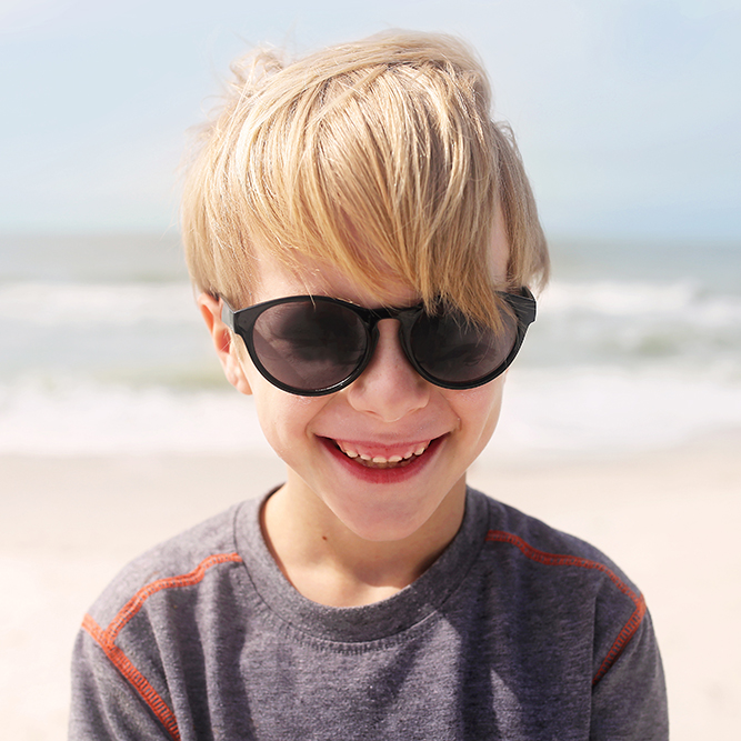 young boy smiling showing his baby teeth