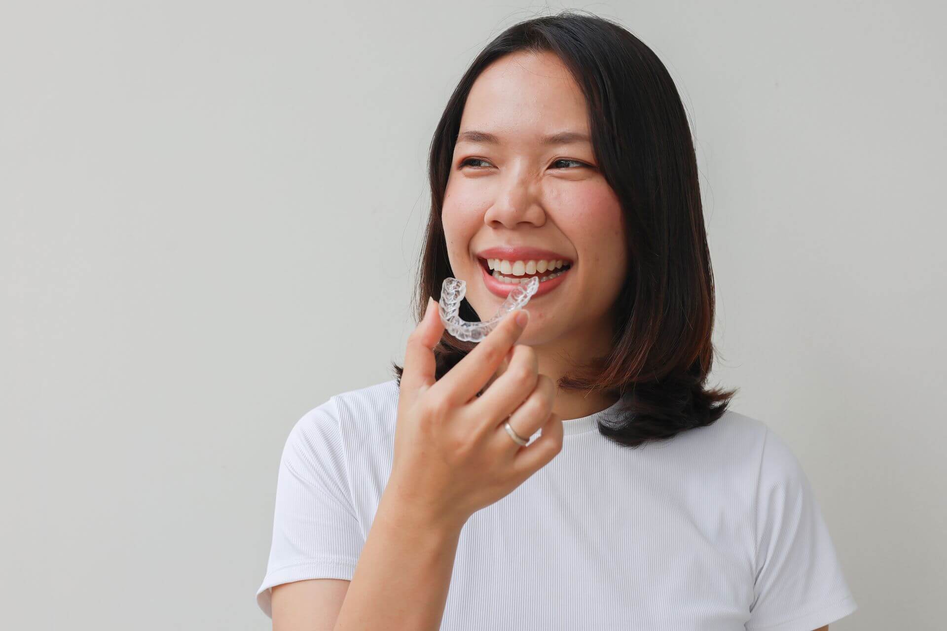 woman holding a clear retainer