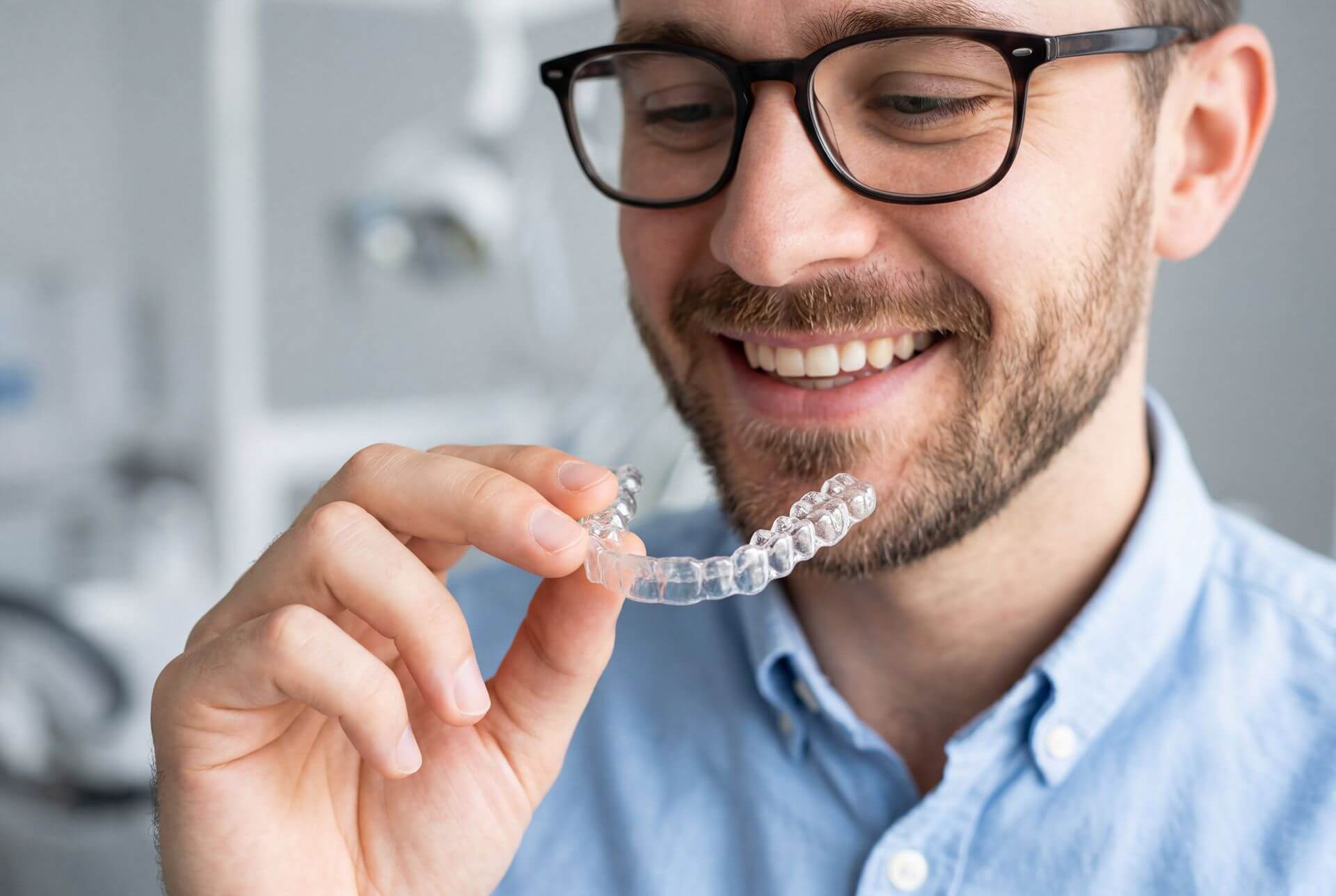 patient holding Invisalign aligners