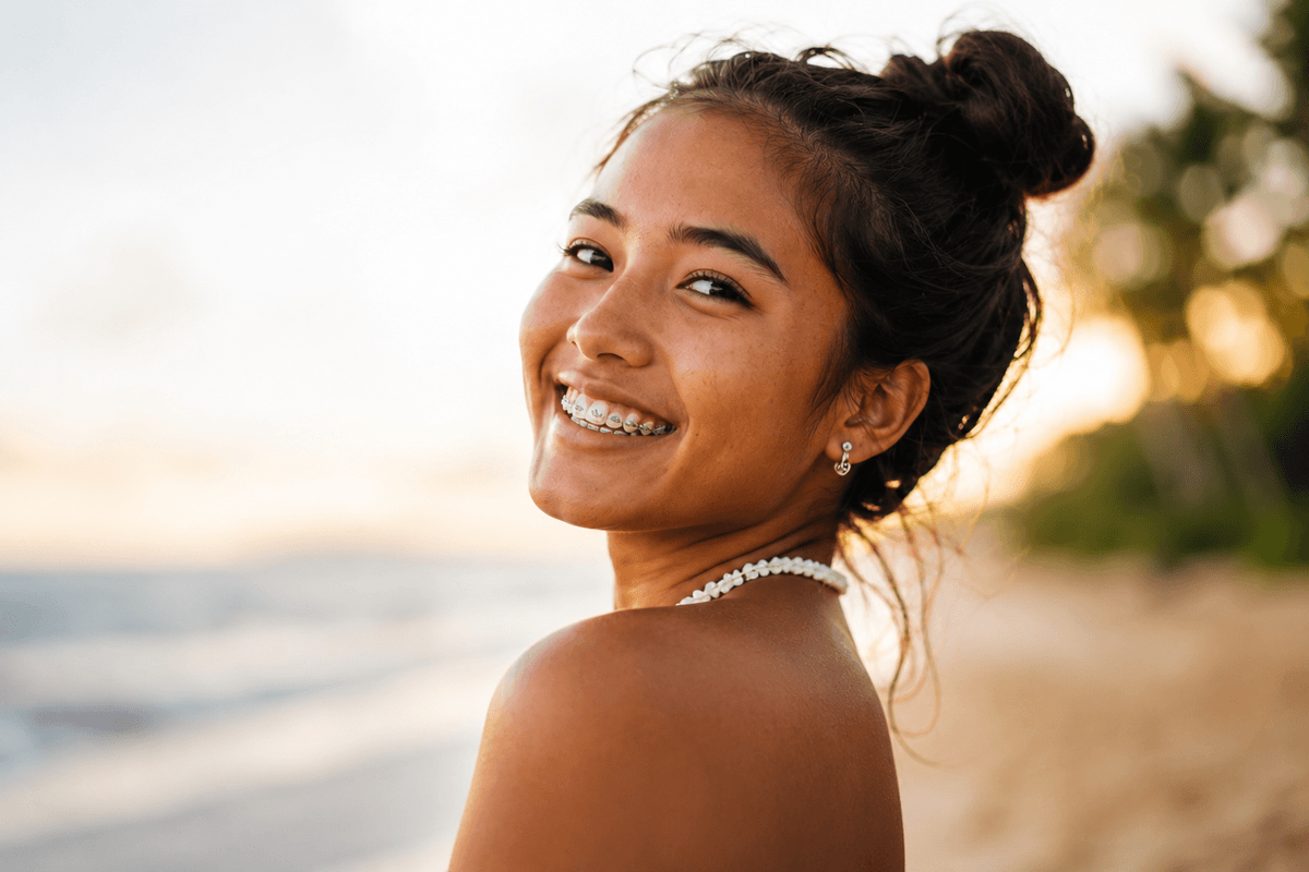 teen girl with braces smiling on the beach